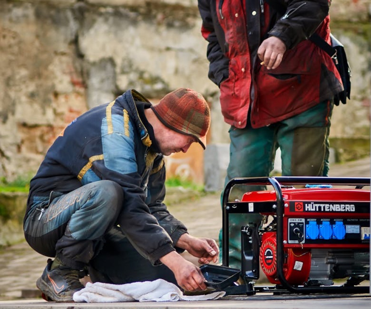 Power generator being serviced by technicians outdoors - maintenance and field reliability matter for backup systems